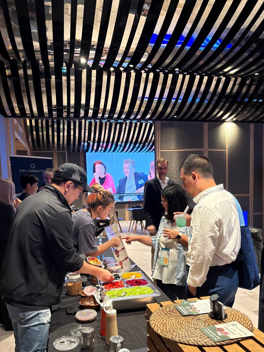 Guests queuing at an Oatberry açaí bowl live station at a Singapore corporate conference